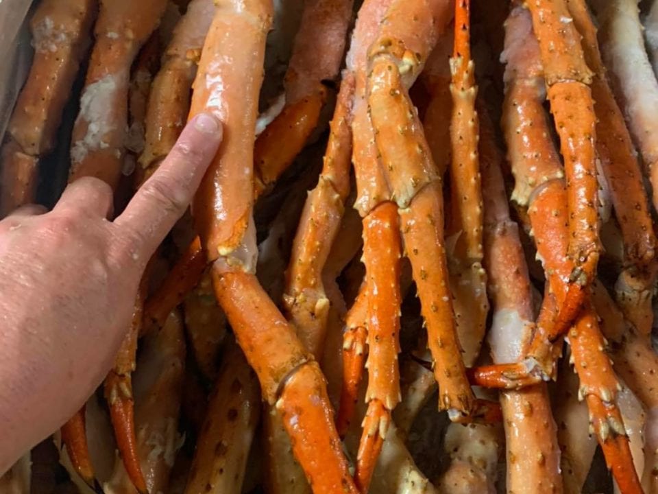 gigantic crab legs with a finger for comparison